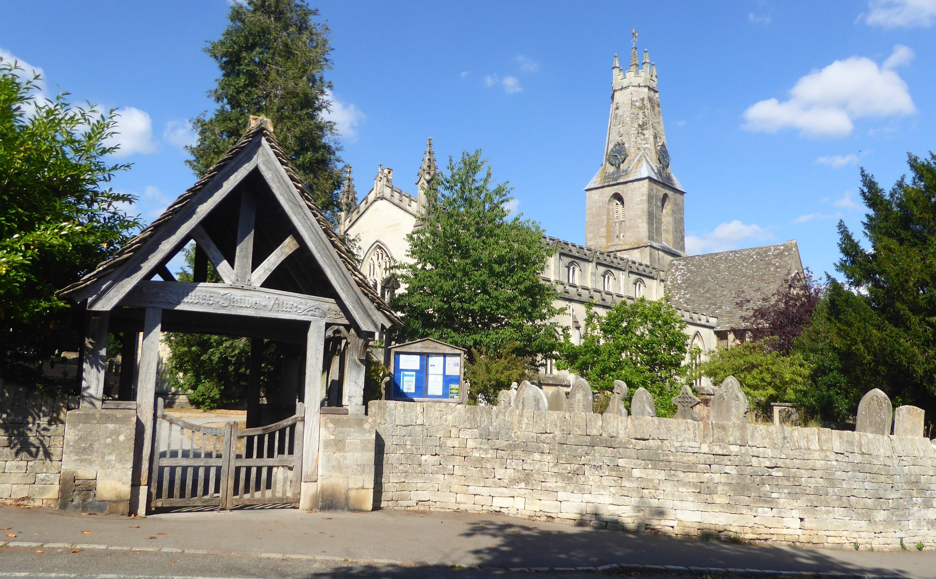 A historic church with a tall tower and a wooden structure in front.