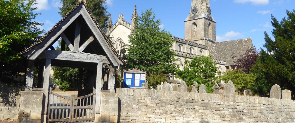 A historic church with a tall tower and a wooden structure in front.