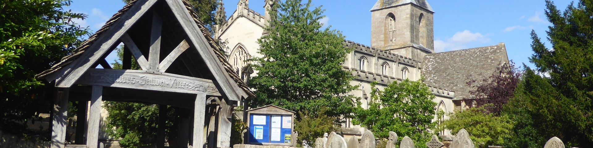 A historic church with a tall tower and a wooden structure in front.