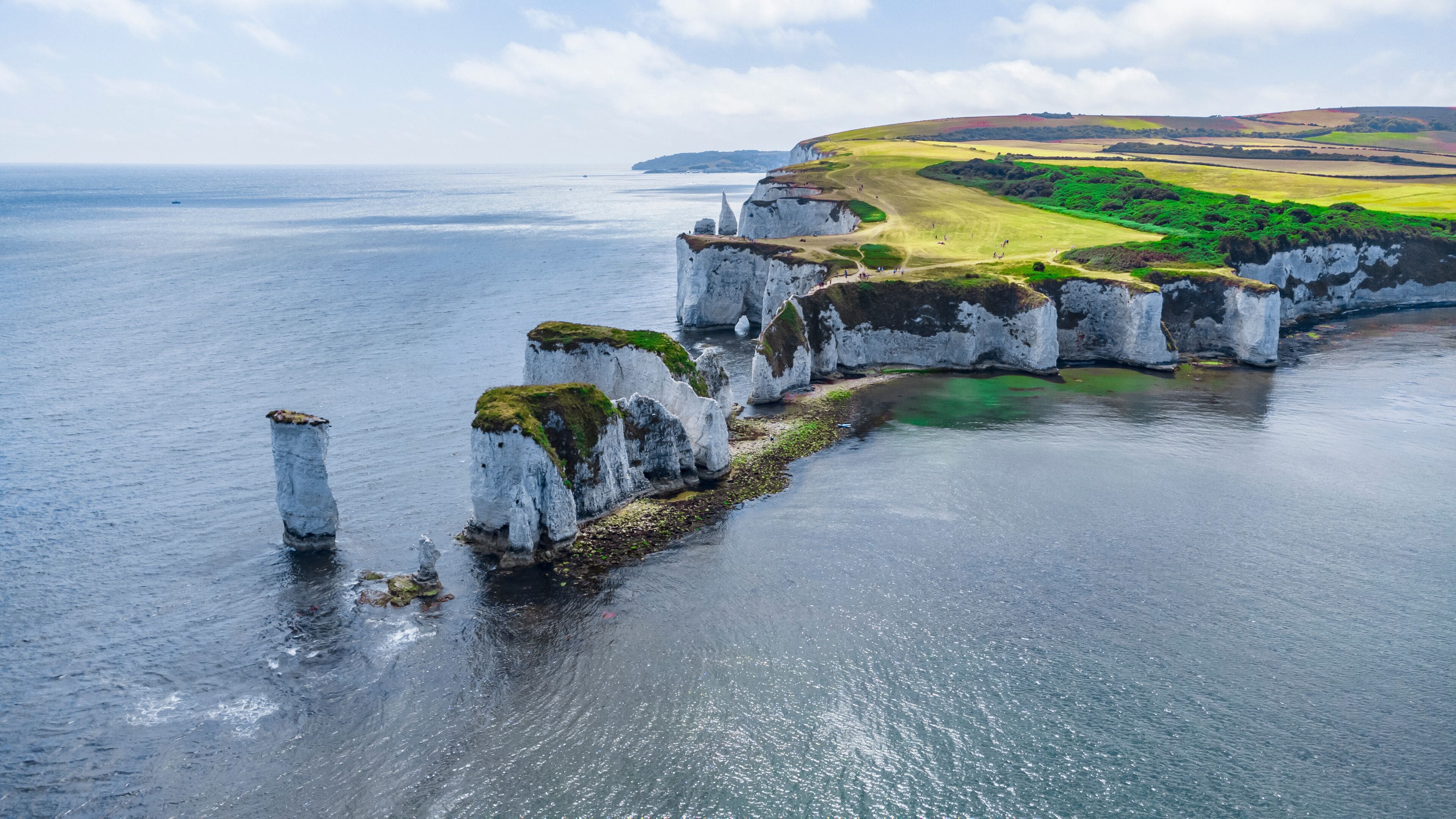 Old Harry Rocks are three chalk formations, including a stack and a stump, located at Handfast Point, on the Isle of Purbeck in Dorset, southern England. They mark the most eastern point of the Jurass