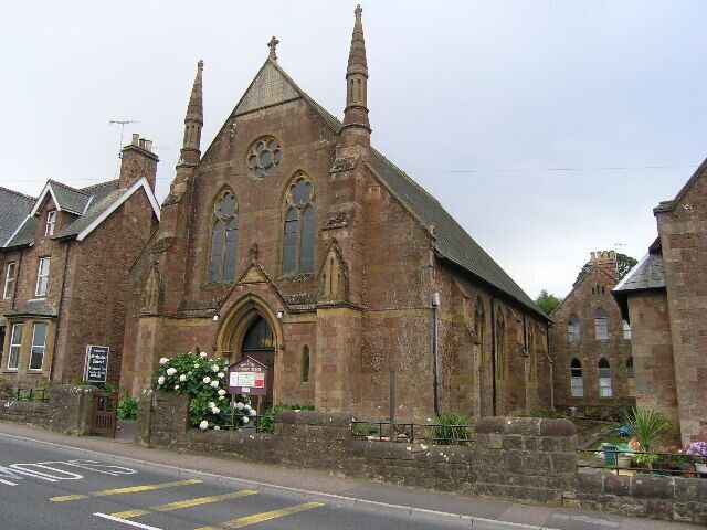 A historic church with a prominent steeple and arched windows.