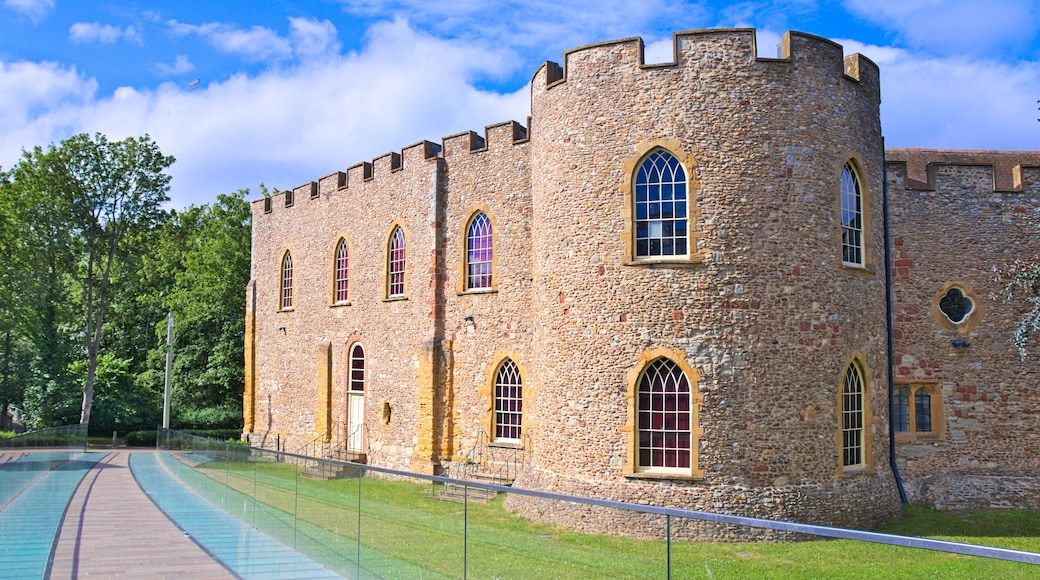 Taunton castle, Somerset Museum, England, Uk. Bright summer morning with blue sky and some clouds, green meadow and trees, glazed walkway