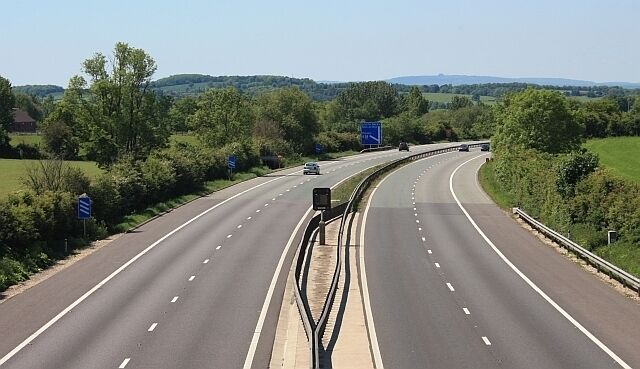 M50 motorway - looking west to Junction 1 Taken from the farm track and public bridleway providing access to Brockeridge Common which was divided when this section of the M50 was built. In the far, grey distance is May Hill with its little landmark "caterpillar" of trees on top.