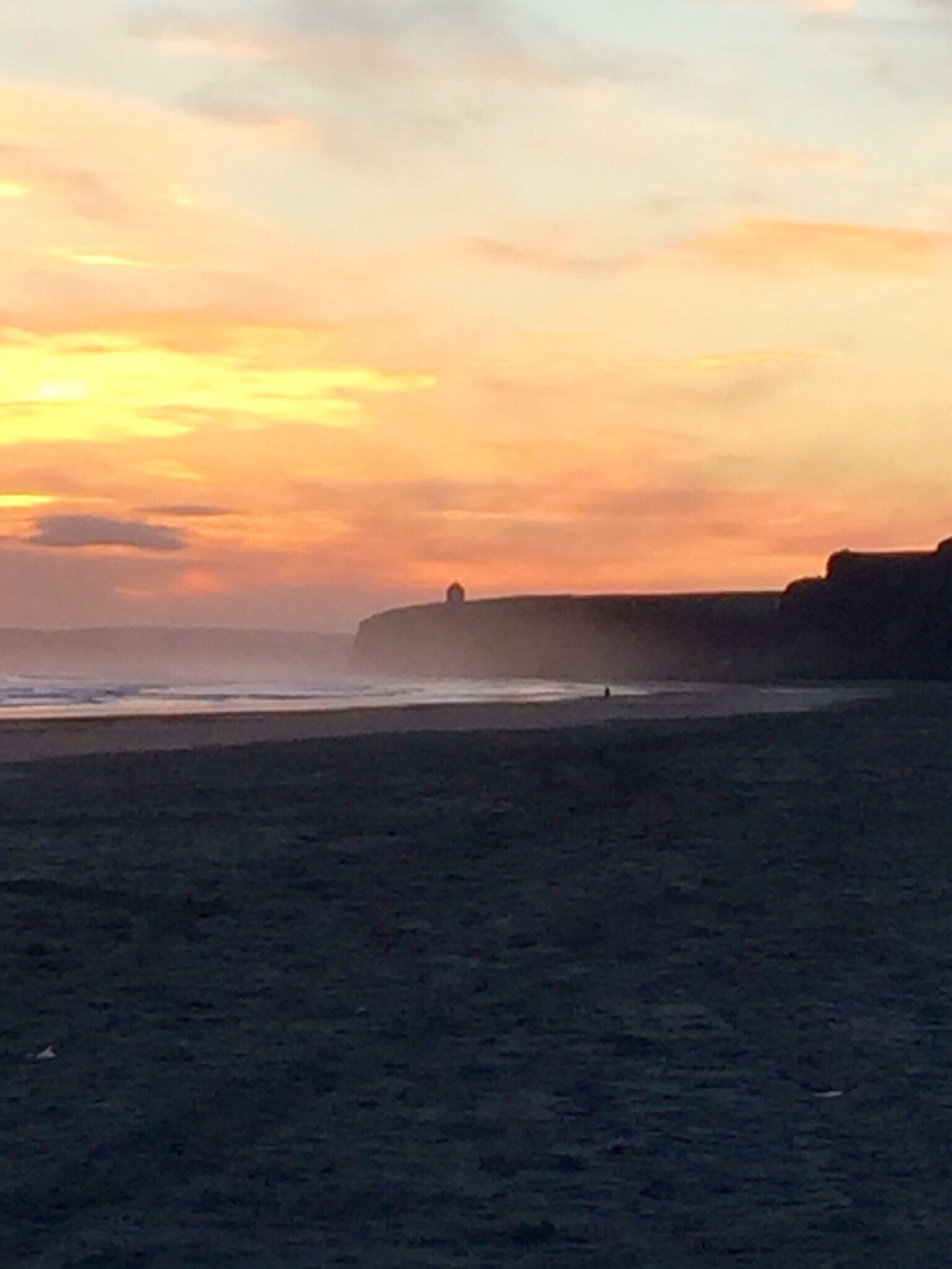 Early morning mist at Benone beach with Mussenden Temple in the distance