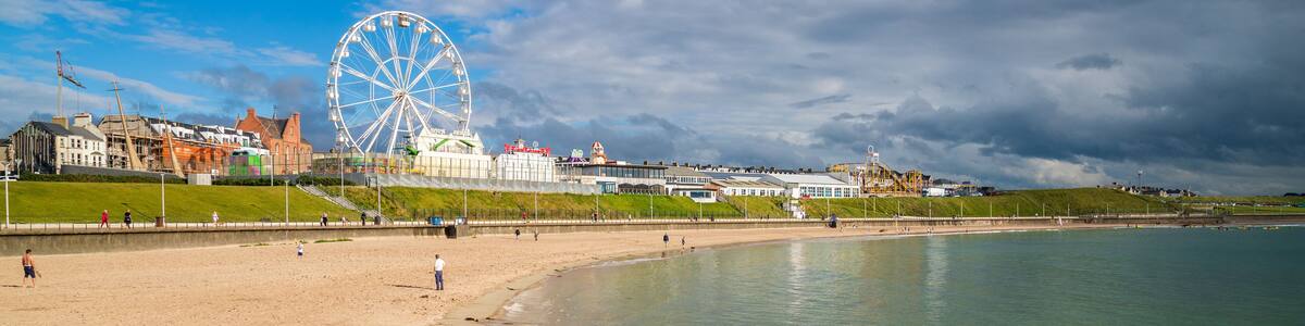 Portrush which includes a sandy beach and general coastal views