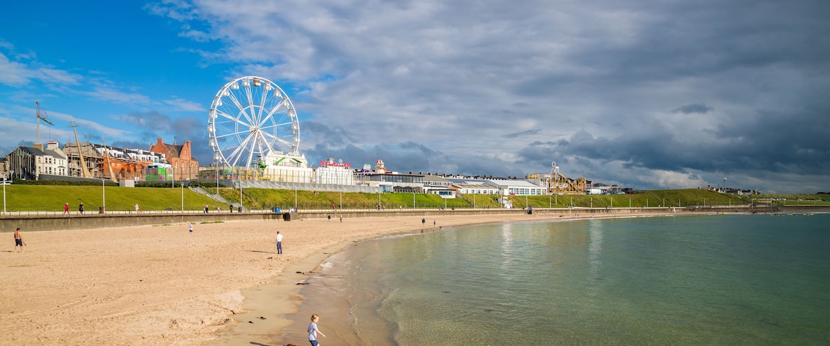 Portrush which includes a sandy beach and general coastal views