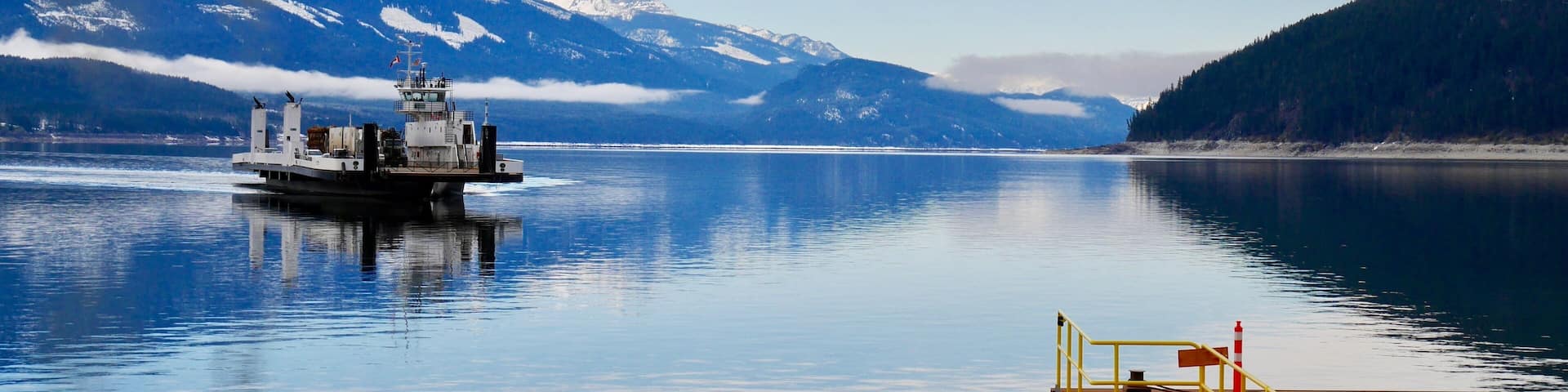 Ferry boat on blue lake. Upper Arrow lake. Columbia River. Selkirk and Monashee Mountains. Keenleyside Dam. Castlegar. Revelstoke. British Columbia. Canada.