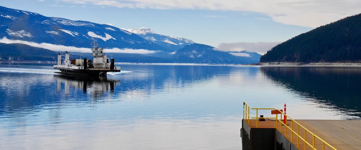 Ferry boat on blue lake. Upper Arrow lake. Columbia River. Selkirk and Monashee Mountains. Keenleyside Dam. Castlegar. Revelstoke. British Columbia. Canada.