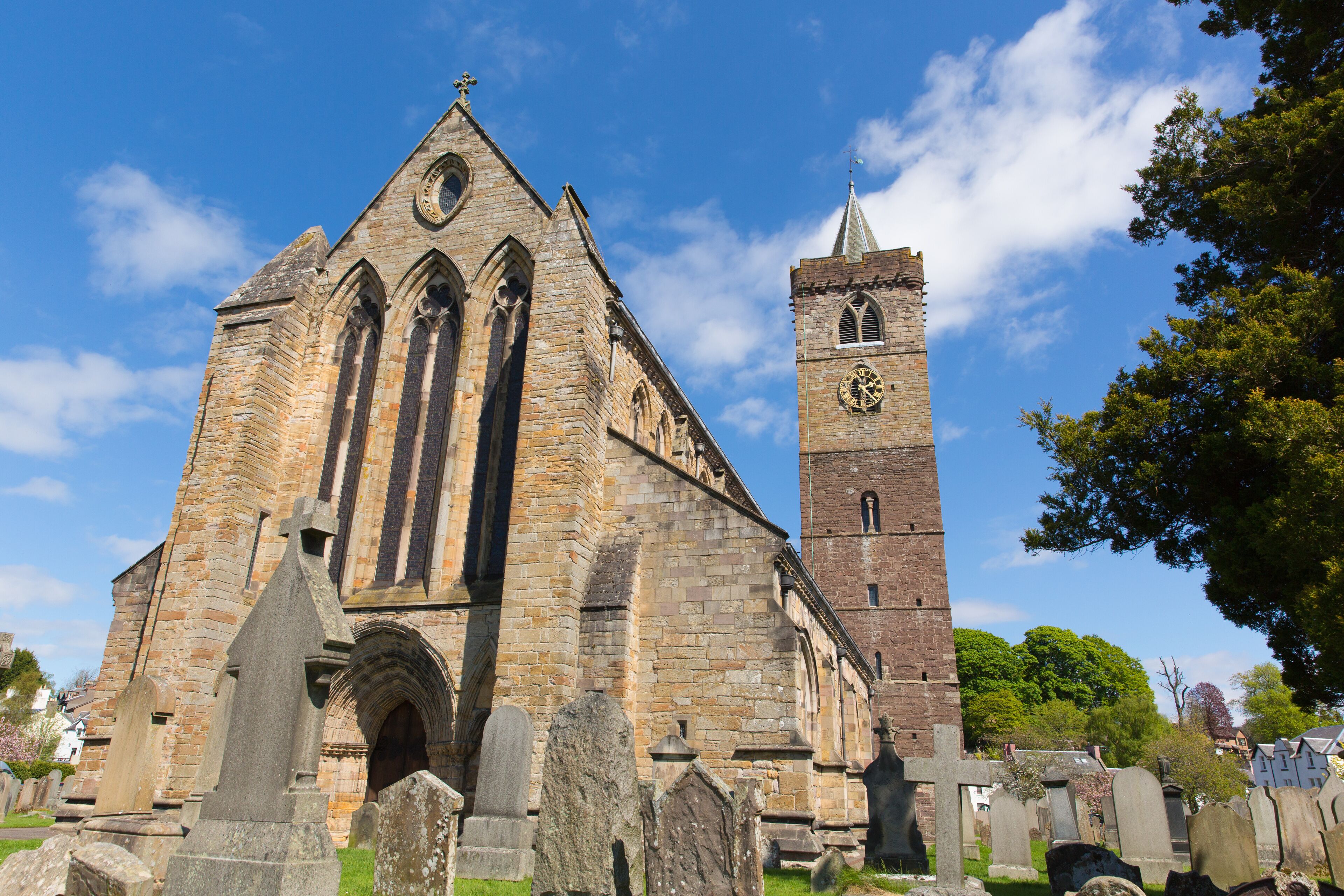 A historic church with a tall clock tower and Gothic architecture.