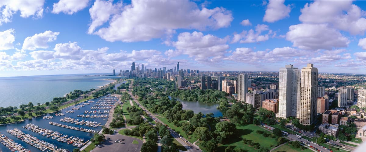 A cityscape with a marina, river, and high-rise buildings.