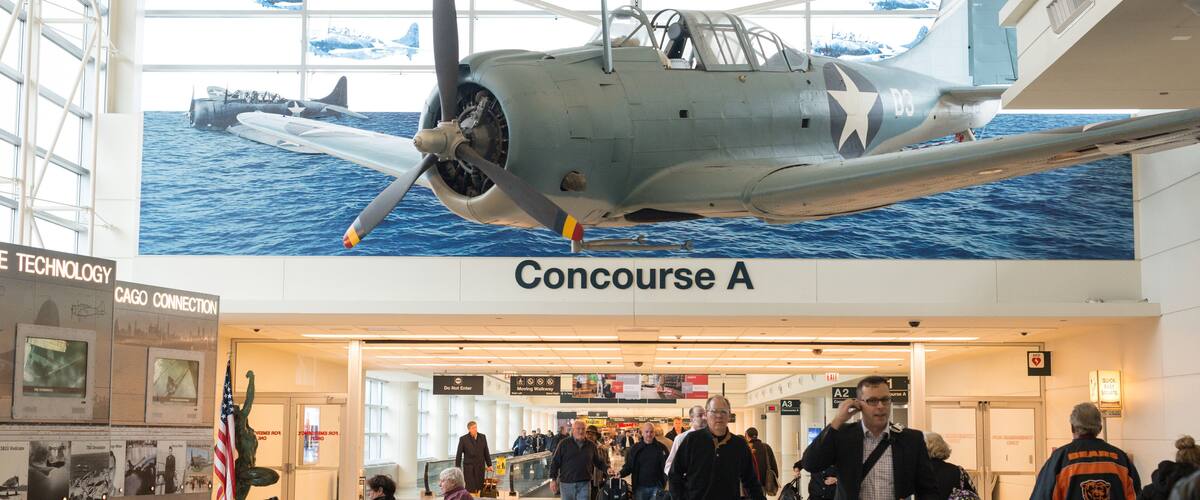 An airplane exhibit labeled "Concourse A" in an airport terminal.