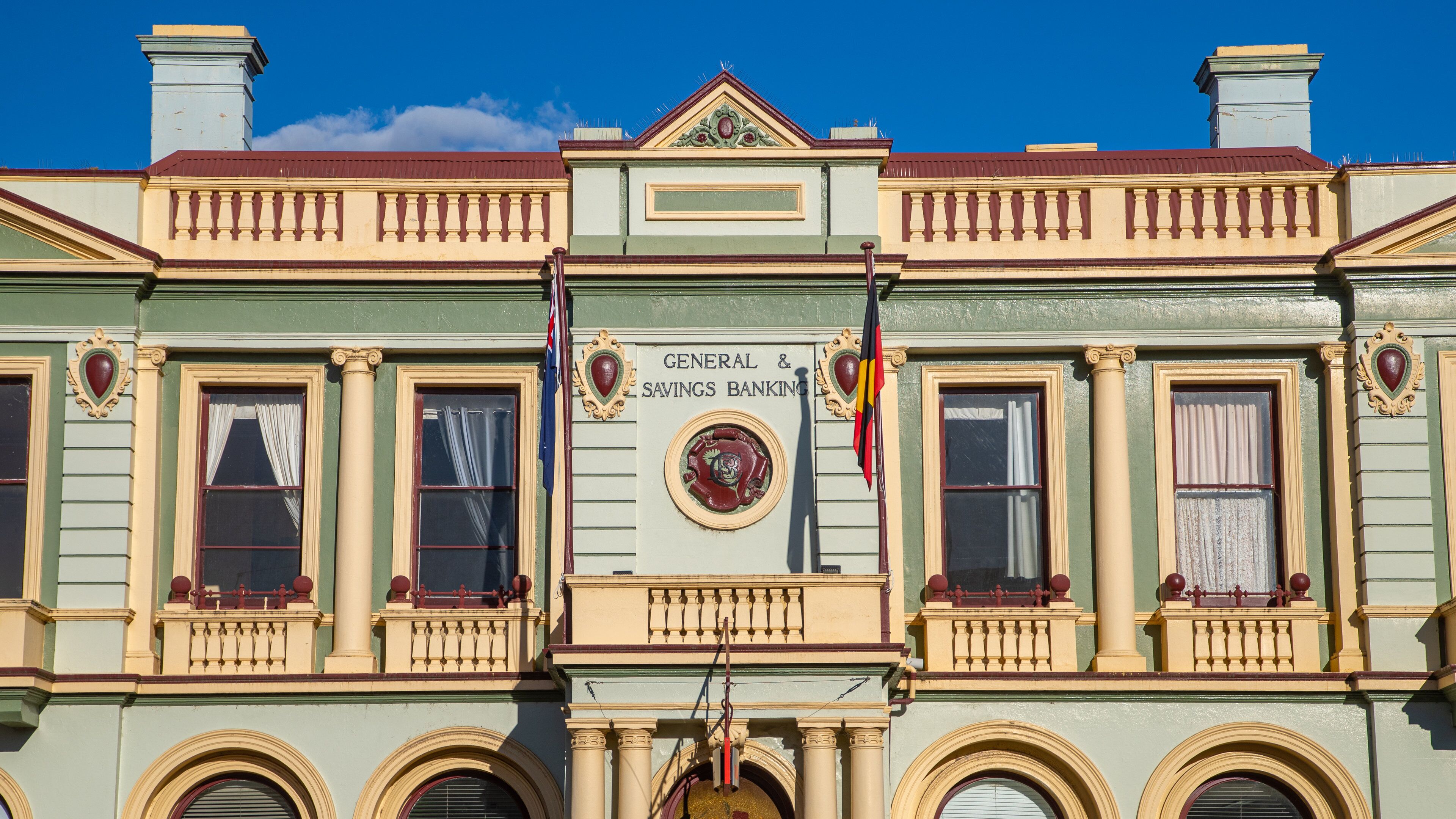 A building with ornate architectural details, including a sign that reads "General & Savings Banking."
