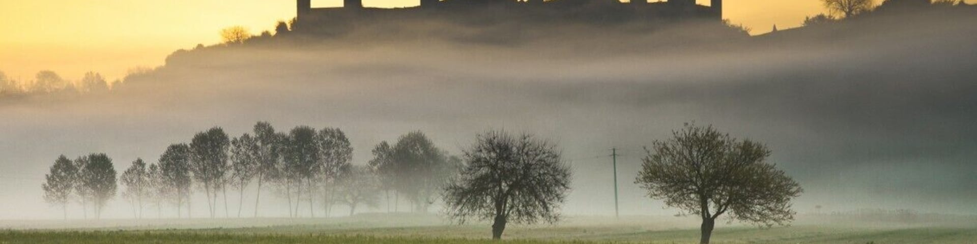 #TroveOn
Yes, Monteriggioni just might be the quintessential walled medieval village in Tuscany. It's small enough to perhaps be called "cute" but you won't catch me using this term.
Monteriggioni began as a border fortress built on a round hill by Sienna against the Florentines. It is famous for the intact defensive structure that held up against repeated Florentine attacks in the 11th century; its 10 meter high walls and 14 towers can still be seen for miles around. Monteriggioni has been featured in movies as a typical medieval village.
The village is slightly elliptical in shape with two gates (a third has been plugged). The major gate tourists will use when coming from the parking lot, Porta Franca, owes its name to the Via Francigena--Monteriggione was a major stop on the pilgrimage trail from Cantebury to Rome. The Romanesque Church of Santa Maria Assunta will offer assistance with housing for modern pilgrims traveling the Francigena pilgrimage route.
Monteriggioni was a sleepy village of farmers and sheep herders as late as the 1960's. Today it exists entirely for tourists and pilgrims. You'll find wine shops, a tasting room, restaurants and hotels in the small village. This is not neccessarily a disadvantage, although some times it's nice to see some locals puttering about once in a while.
Where is Monteriggioni?
Monteriggioni is located in the province of Siena, 14km to the northwest of Siena (54km from Florence). While it can be done as a day trip from Siena, you might be better off staying the night--Monteriggioni is much more evocative when the tourists leave late in the afternoon and you can sit in a courtyard sipping a glass of Chianti. Monteriggioni is surrounded by vineyards, and is known for its wine production.