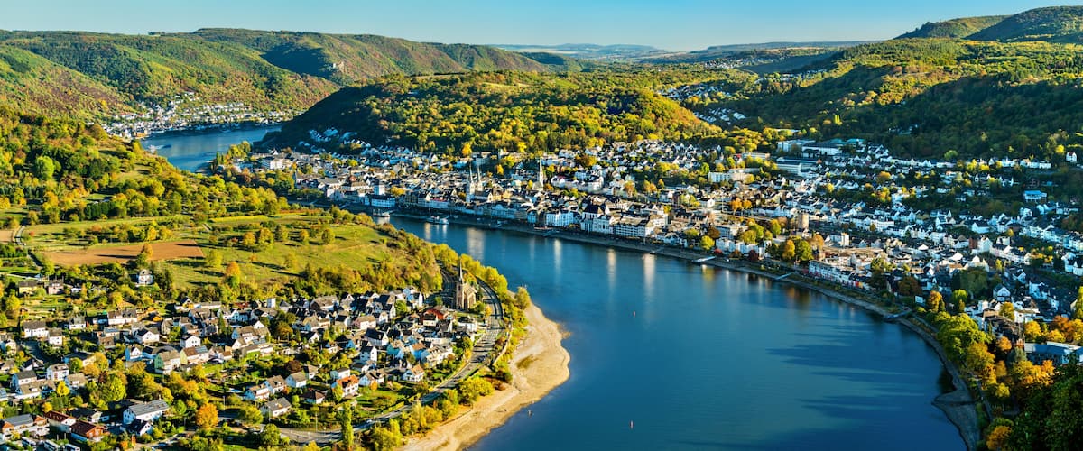 A river winding through a town surrounded by hills.