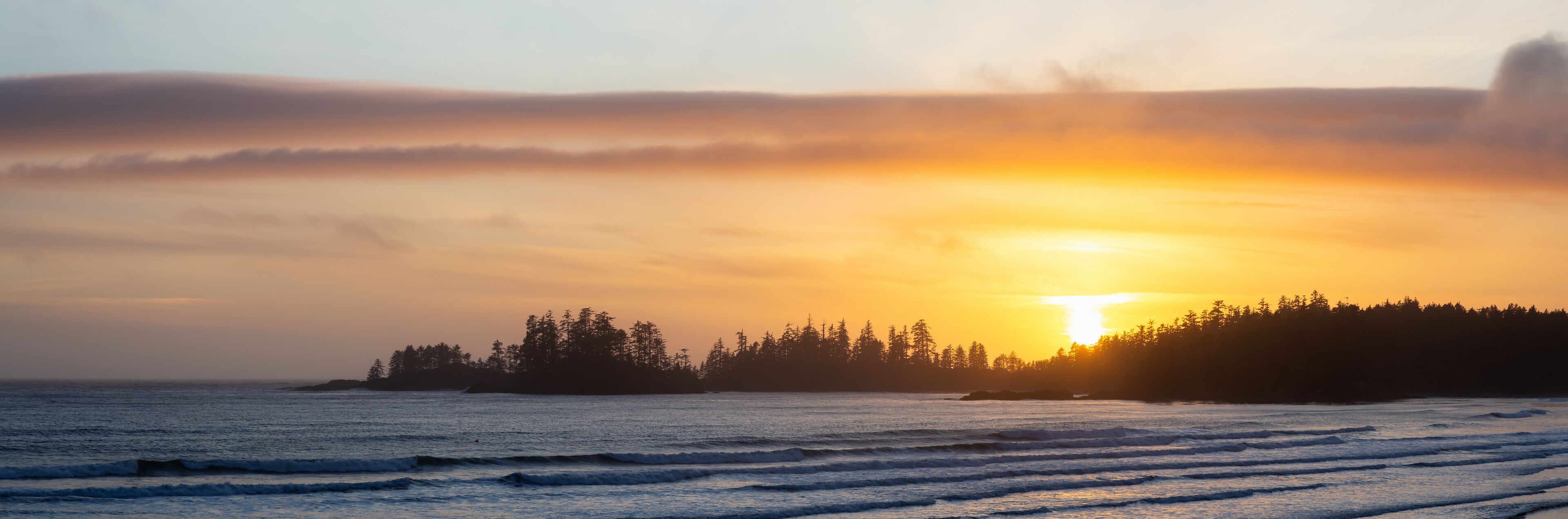Long Beach, Near Tofino and Ucluelet in Vancouver Island, BC, Canada. Beautiful panoramic view of a sandy beach on the Pacific Ocean Coast during a vibrant sunset.