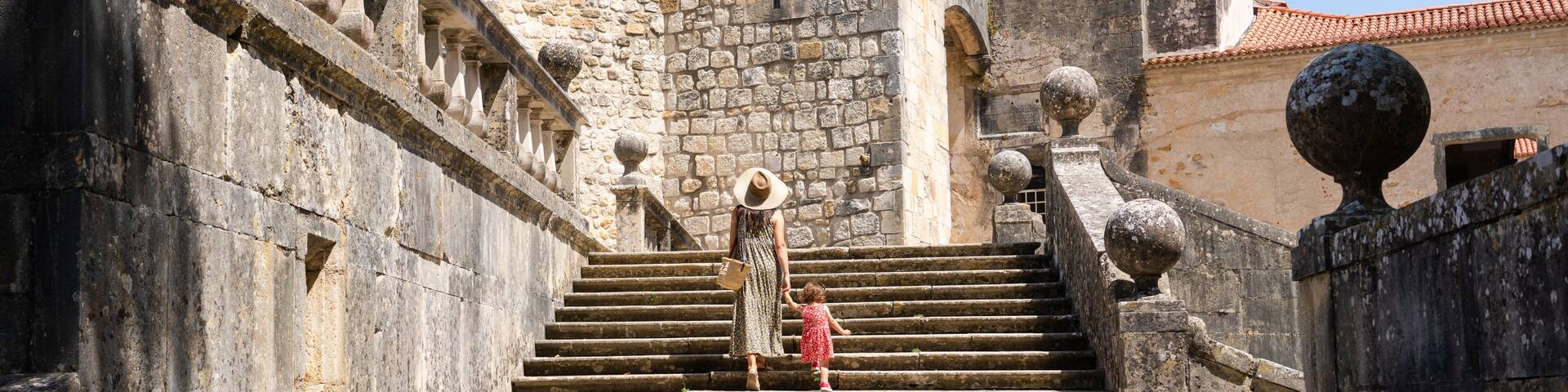 Traveling mom and little girl visiting a castle