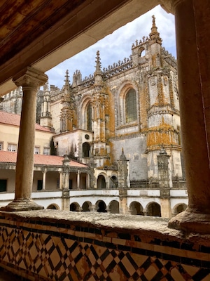 A historic building with ornate architecture, including arched windows and intricate stonework.