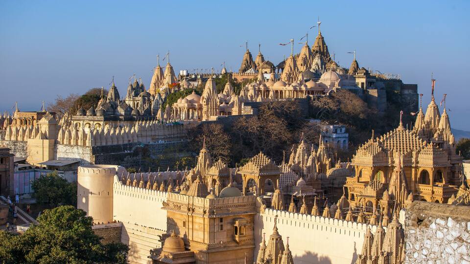 A historic hilltop city with ornate architecture and a prominent temple.
