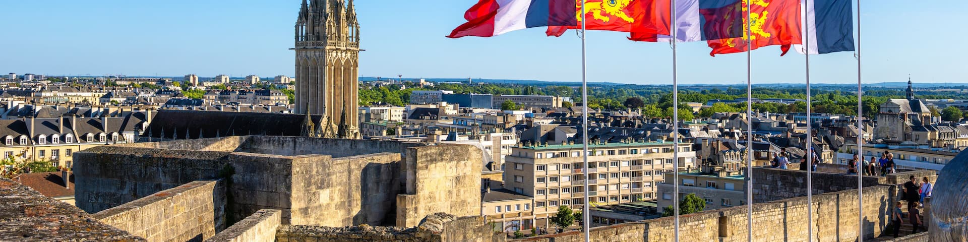 Panoramic view of the historic city of Caen, Normandy, France. French flags and flags of the city of Caen.