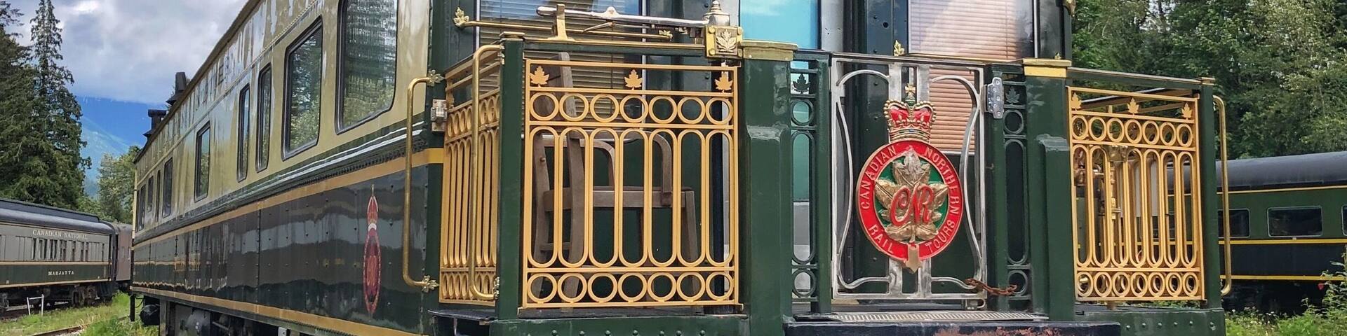 A vintage green train with ornate gold detailing and a crown emblem on the front.