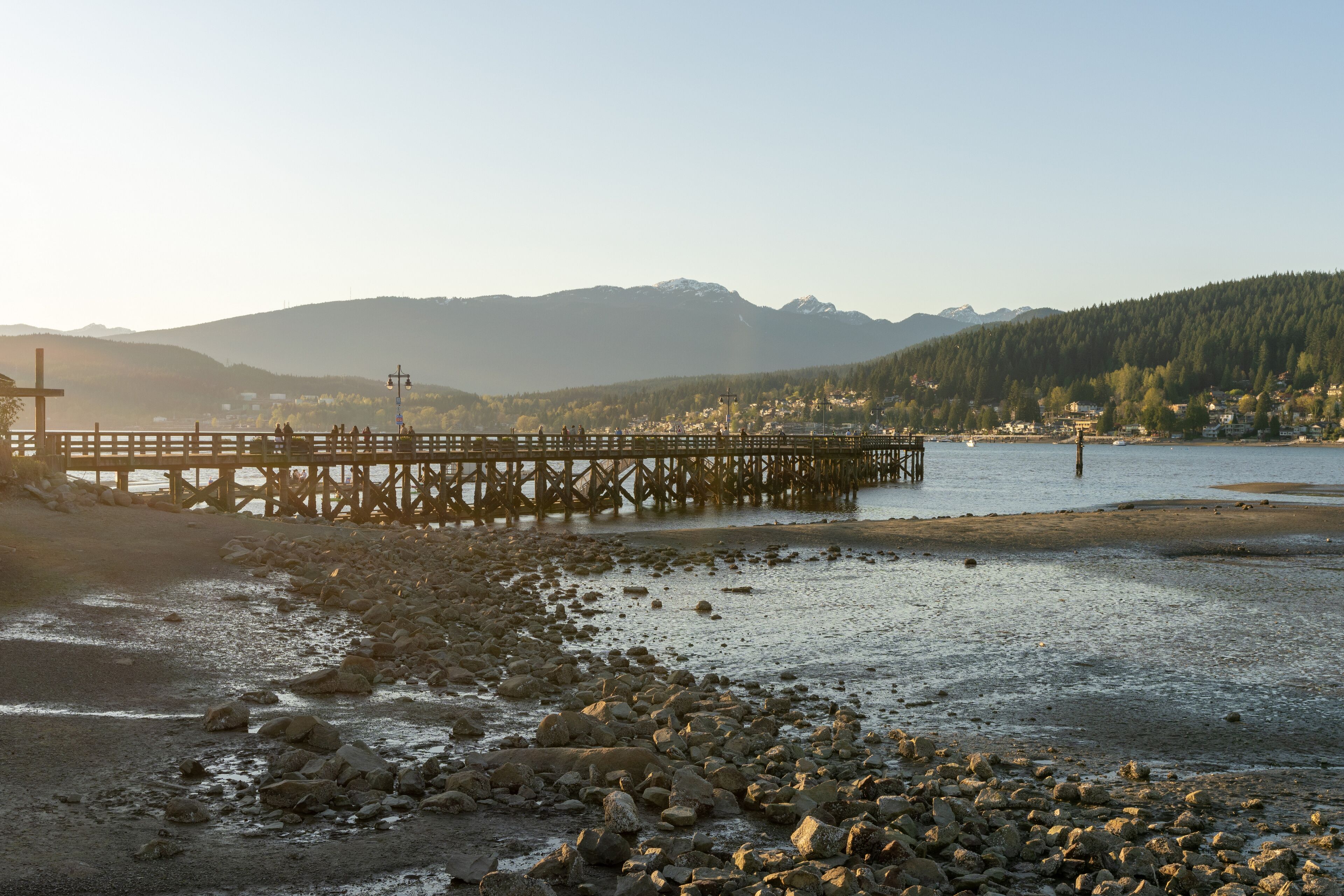 Rocky Point Park during sunset time. Long pier over the ocean. Port Moody, BC, Canada.