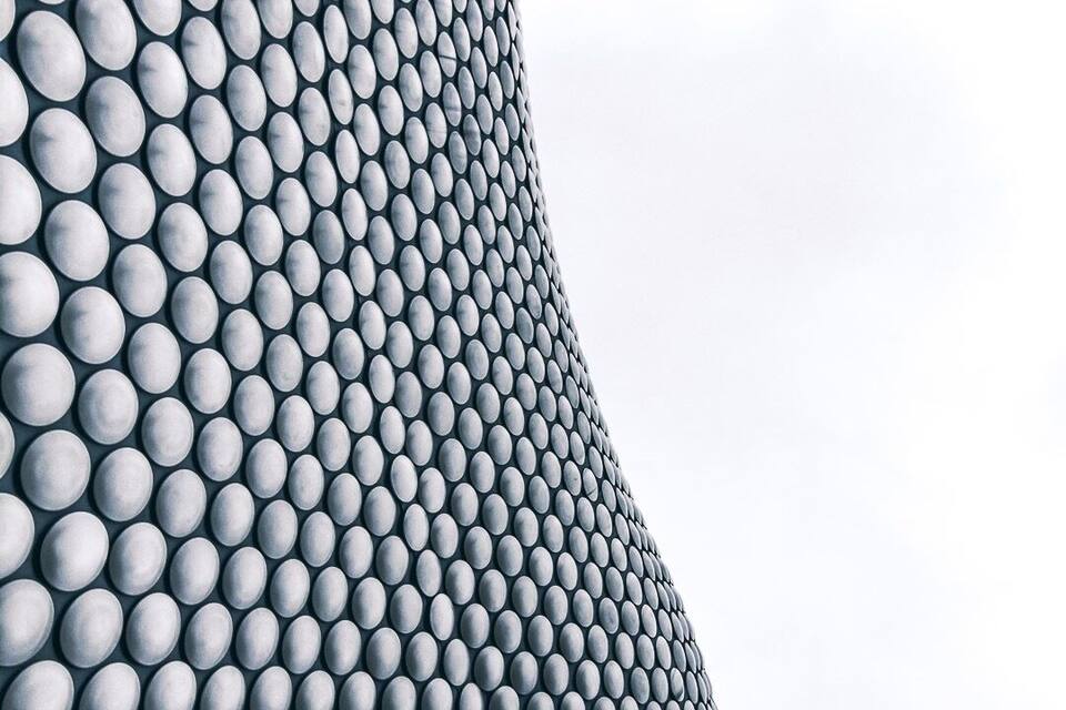 A close-up of a textured surface with a pattern of uniformly sized, rounded shapes.