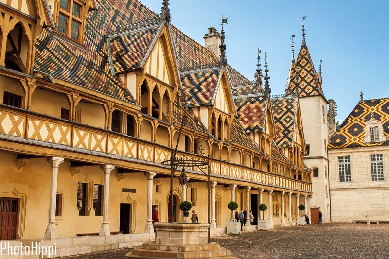A historic building with ornate gabled roofs and a courtyard.