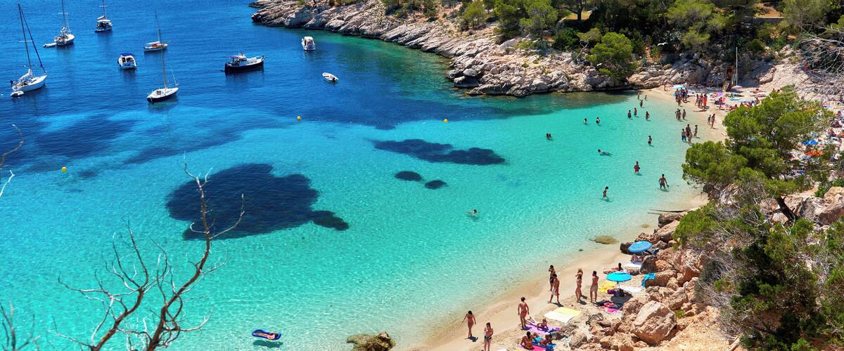 People enjoying vacations in the Cala Salada lagoon. Idyllic scenery. Ibiza, Balearic Islands. Spain