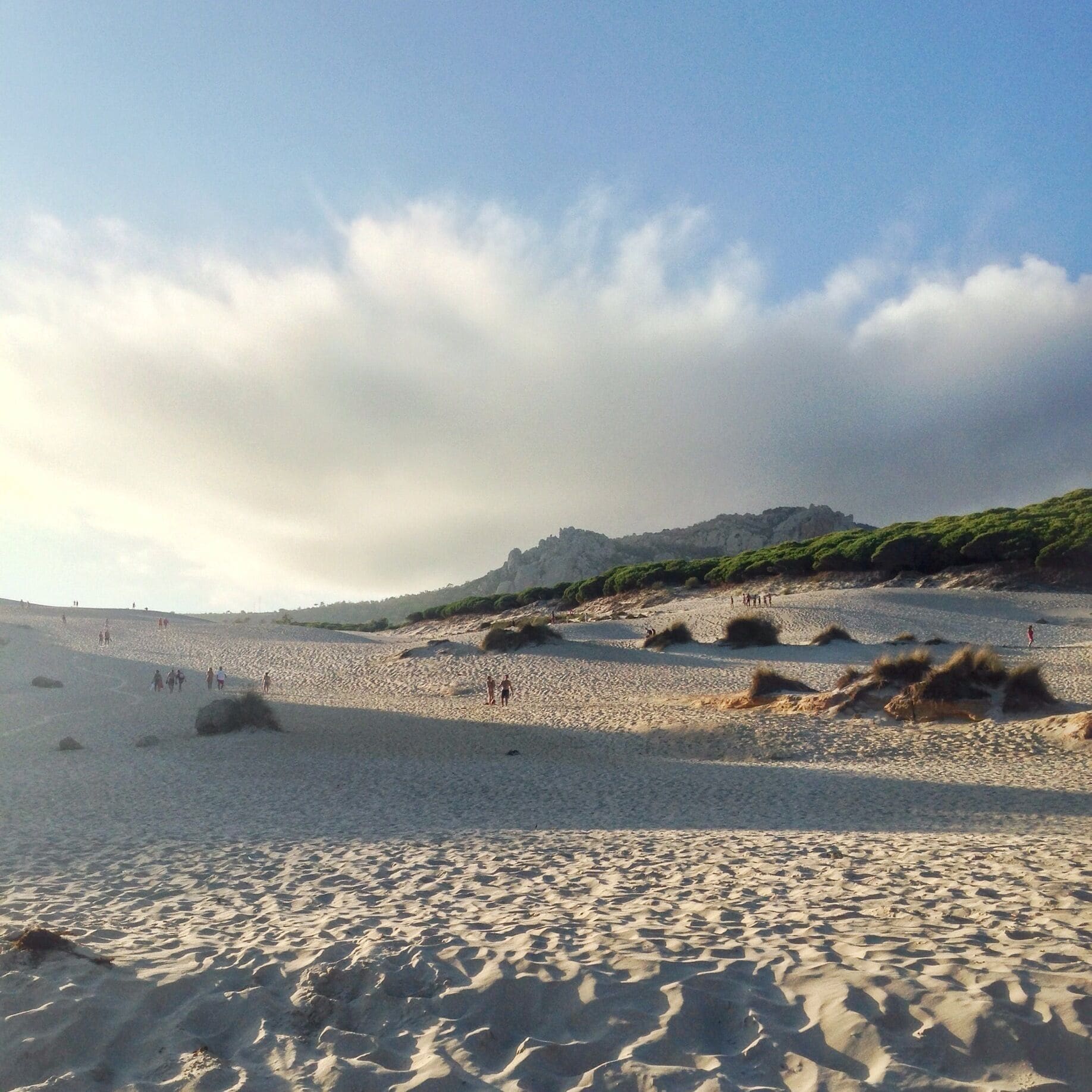 The beach at Bolonia de Cádiz in the southern part of Spain has a completely unique feature - a giant sand dune you can climb up. You won't see much over the other side, but it's worth going up to get a spectacular view of the coastline. 

The secret is out about this beach, though. While it used to be a hippie haven and natural paradise, beach bars and crowds have been popping up more recently. It's still a beautiful beach to visit!