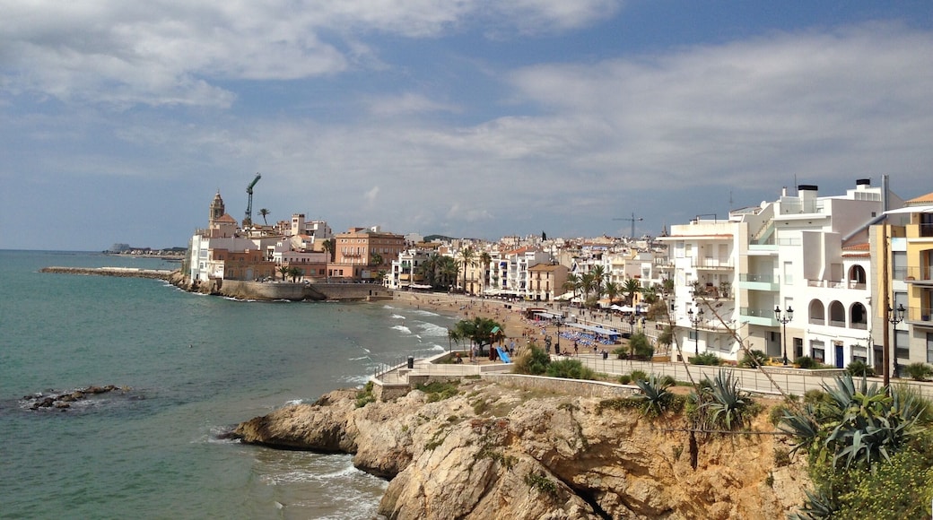 Sitges' rocky coastline with pretty pastel-colored houses