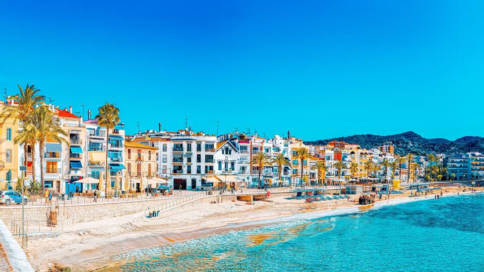 View of the beach and the sea shore of a small resort town Sitge