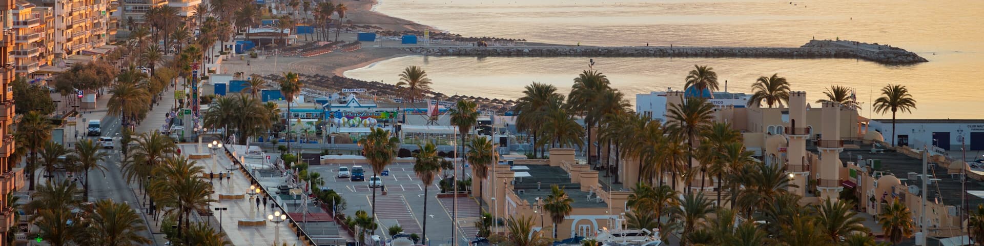 Fuengirola which includes a sunset, a coastal town and landscape views