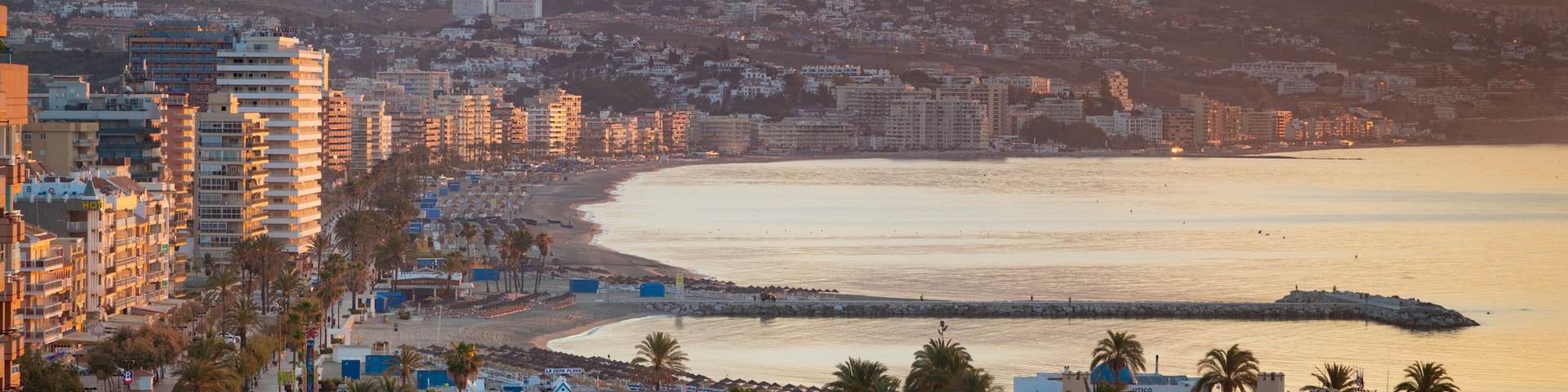 Fuengirola which includes a sunset, a coastal town and landscape views