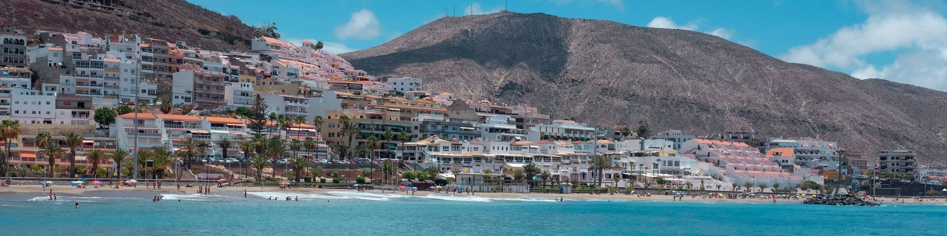 Panoramic view of the tropical Playa de Las Vistas, one of the most popular beaches in the south of the island with friendly waves and fine sand, nearby Los Cristianos, Tenerife, Canary Islands, Spain