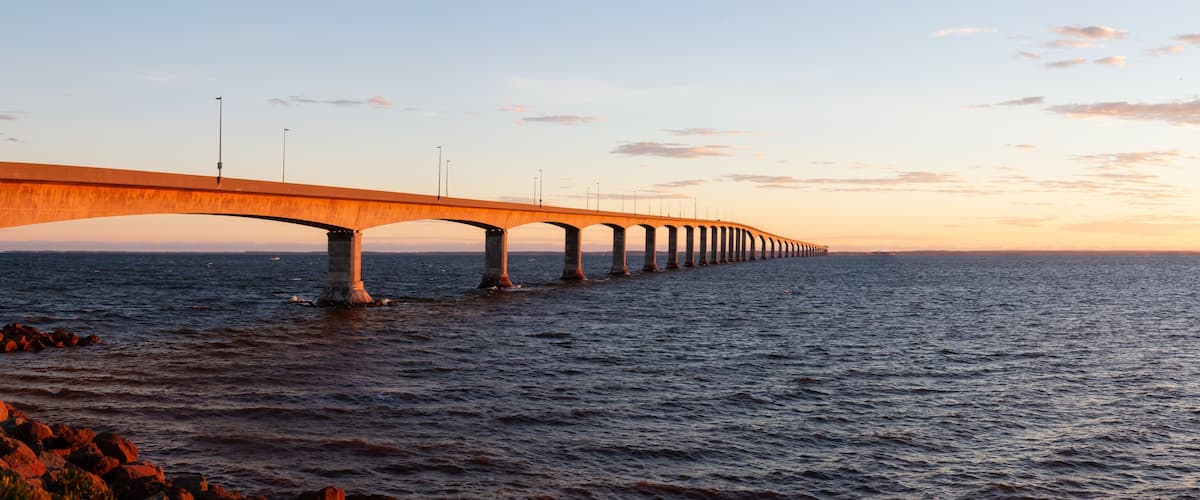 Panoramic view of Confederation Bridge to Prince Edward Island during a vibrant sunny sunrise. Taken in Cape Jourimain National Wildlife Area, New Brunswick, Canada.