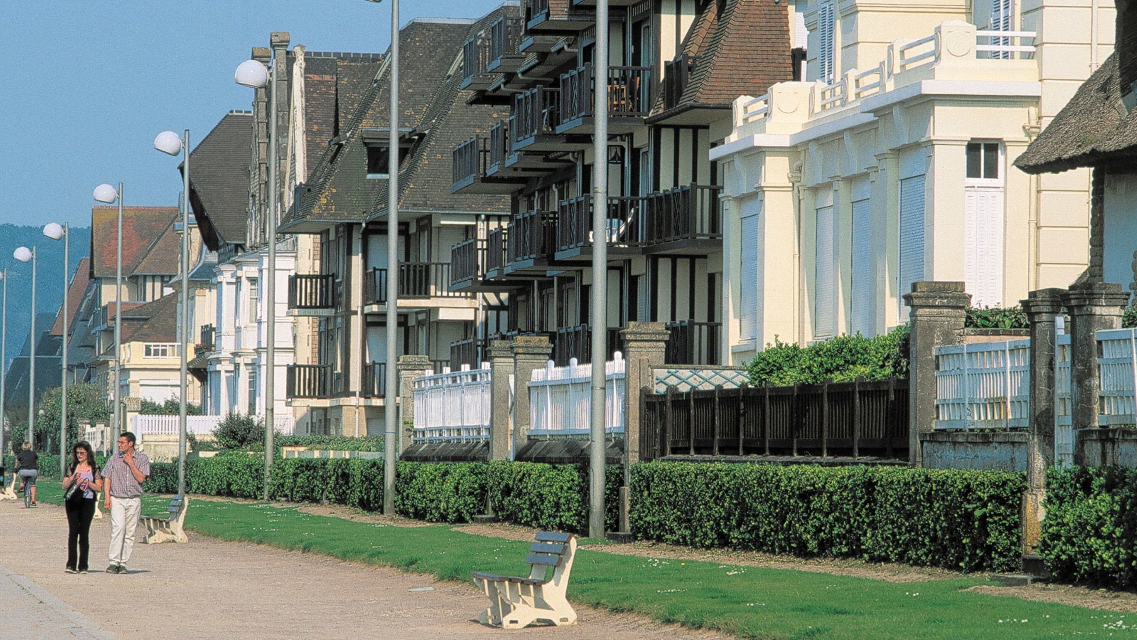 Cabourg showing a house and street scenes as well as a couple