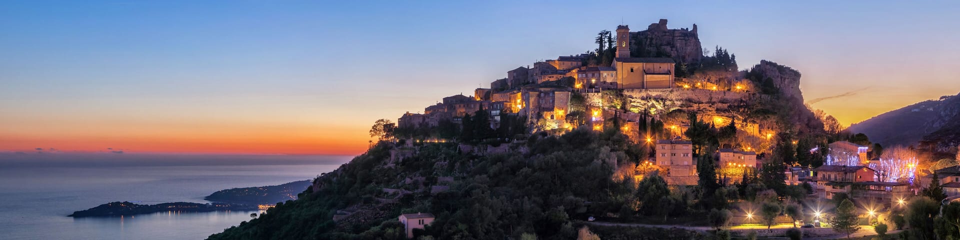 Panoramic view of medieval hilltop village Eze at dusk, Alpes-Maritimes, France