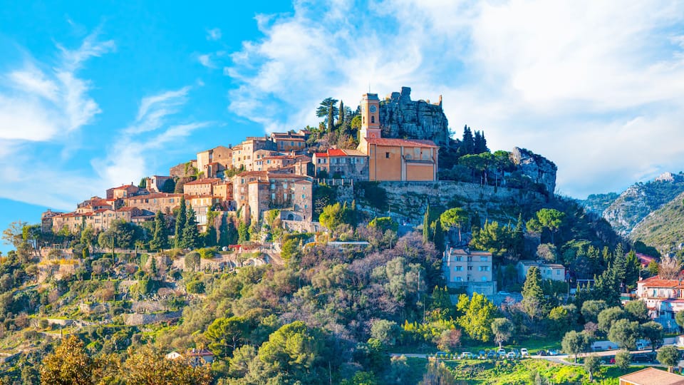 A historic town perched on a hill with a prominent church and castle-like structure.