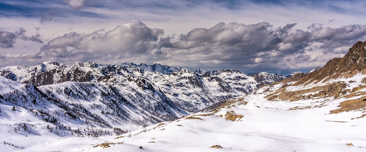 A snow-covered mountain range with a clear sky.