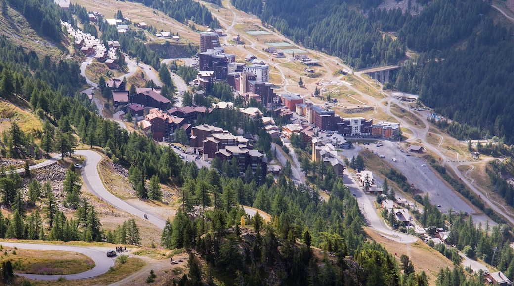 Overview of mountain resort village Isola 2000 in the french alps during summer with the Col de Lombarde mountain pass road