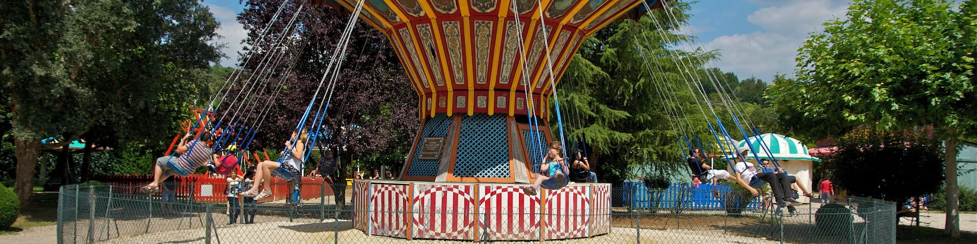 A chair-O-planes carousel, old village of Le Bournat, Le Bugue, Dordogne, France.