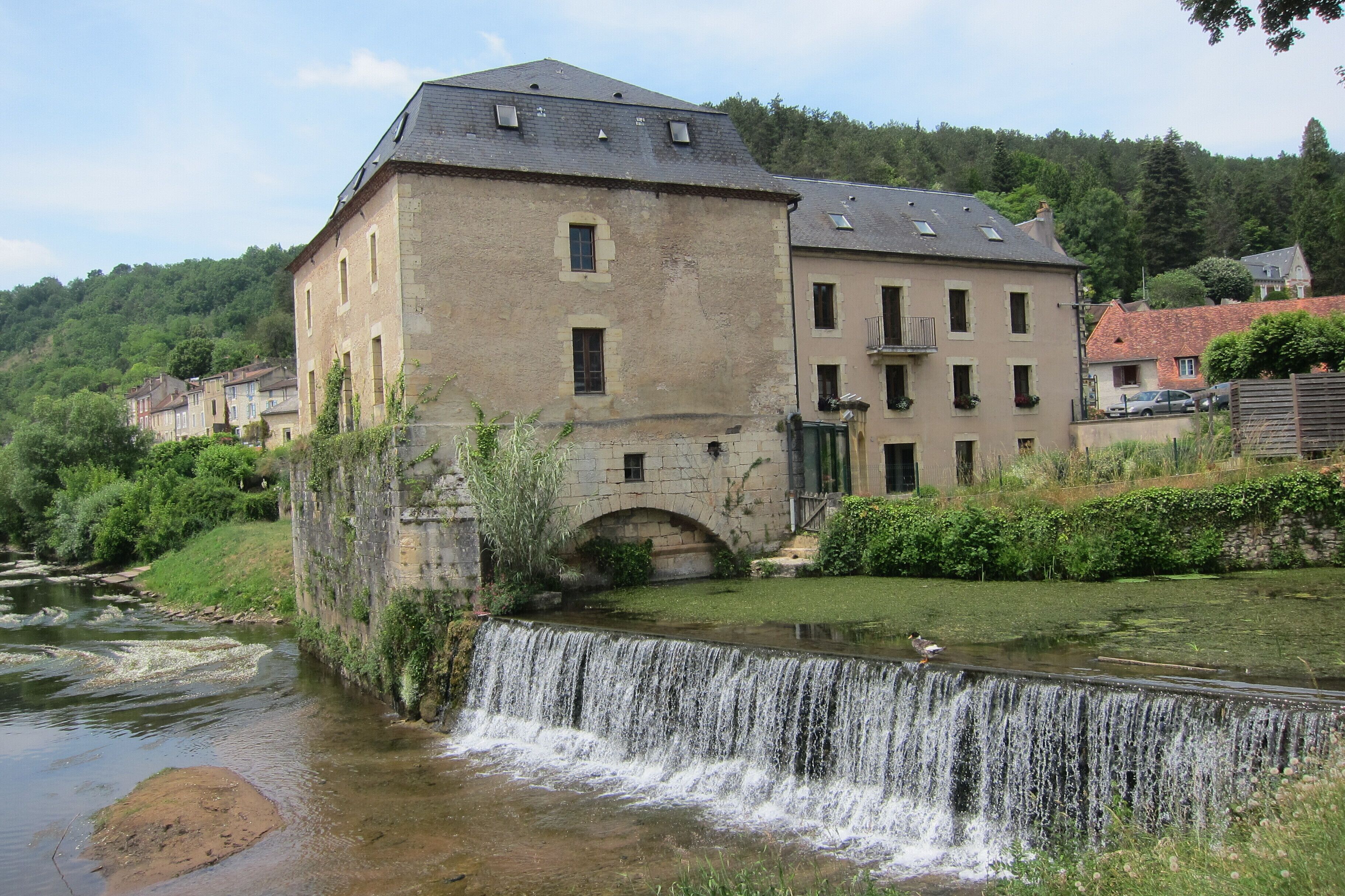 Typical Dordogne panorama (Library of Le Bugue) with waterfall near Le Buge