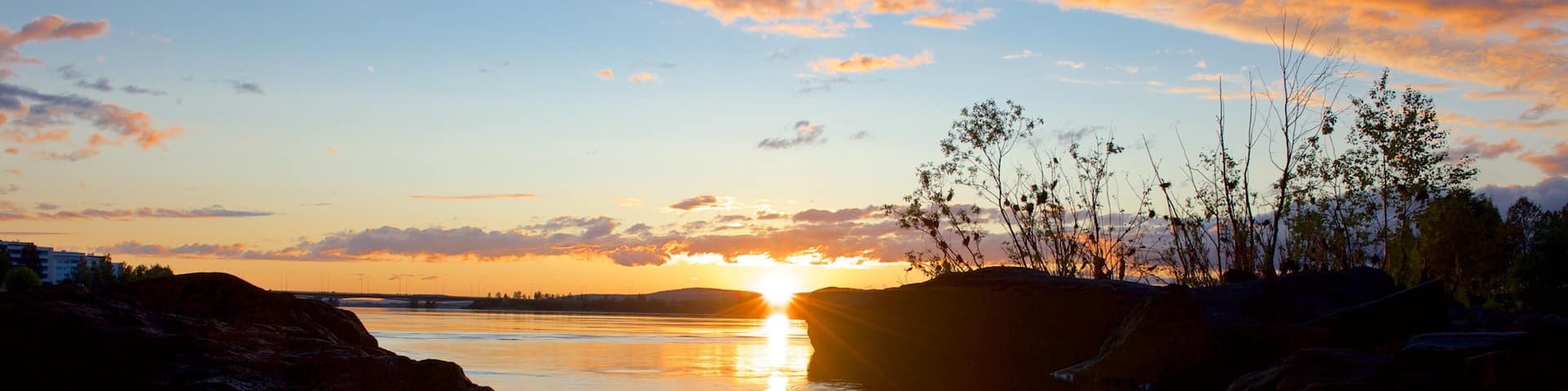 Finland featuring a sunset and a lake or waterhole