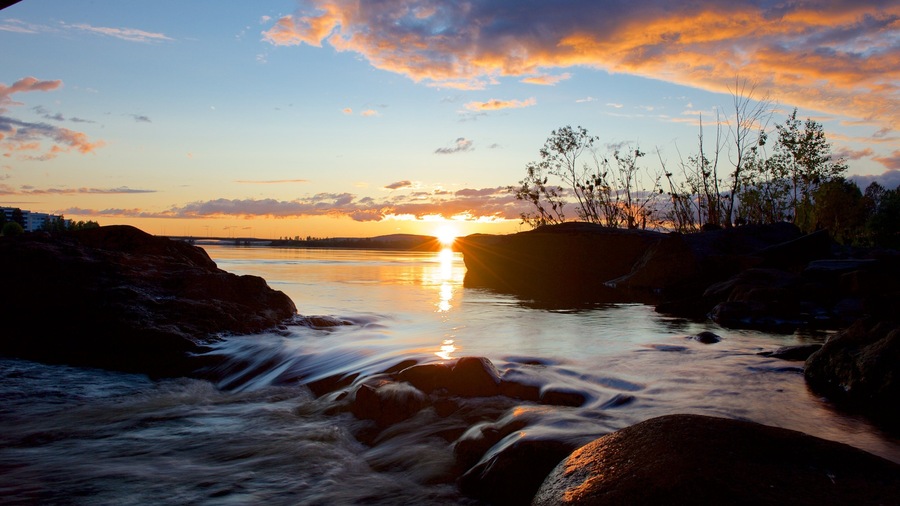 Finland featuring a sunset and a lake or waterhole