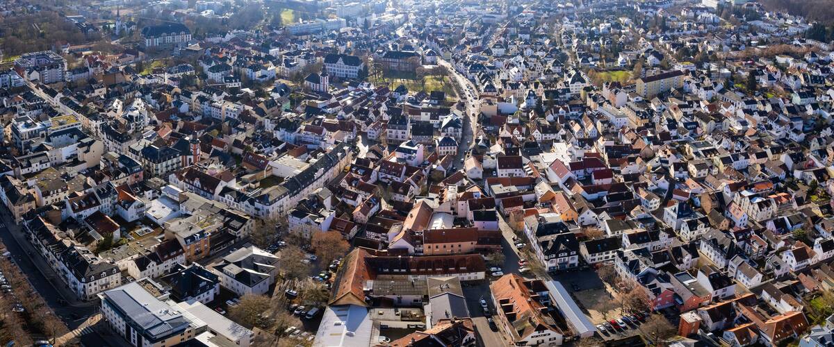 An aerial view of a densely packed urban area with numerous buildings and streets.