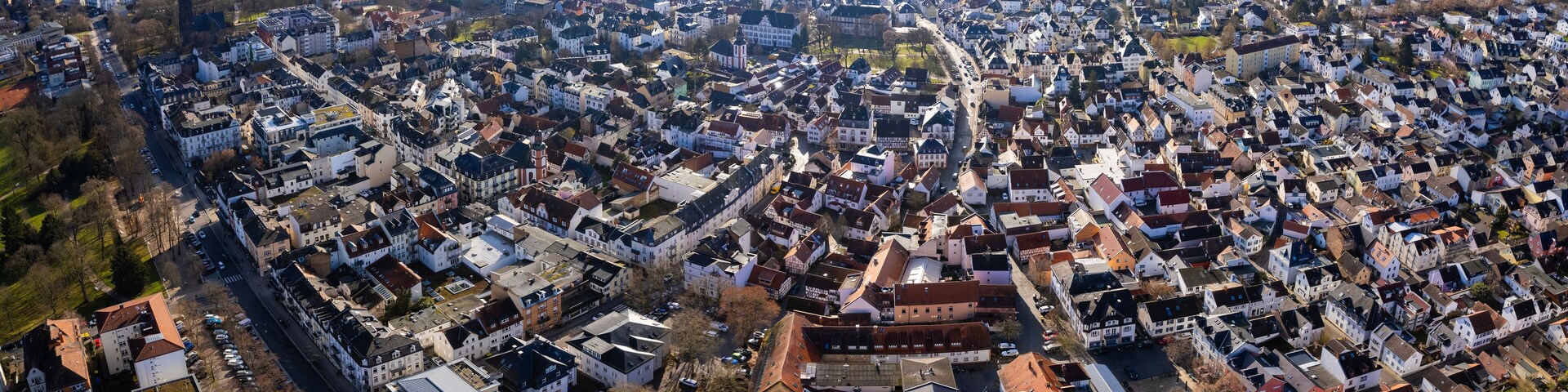 An aerial view of a densely packed urban area with numerous buildings and streets.