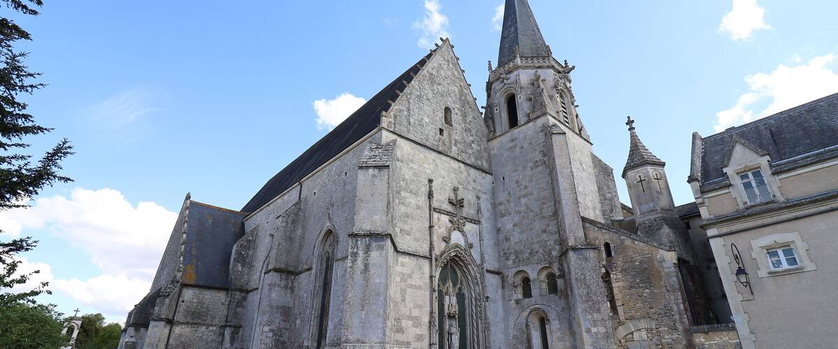 A historic church with a tall spire and a large arched entrance.