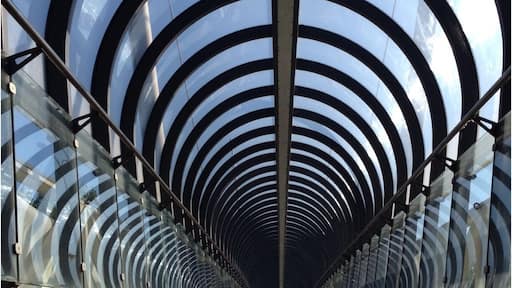 A sunny fall day makes a boring highway pedestrian bridge appear like an architecural masterpiece.