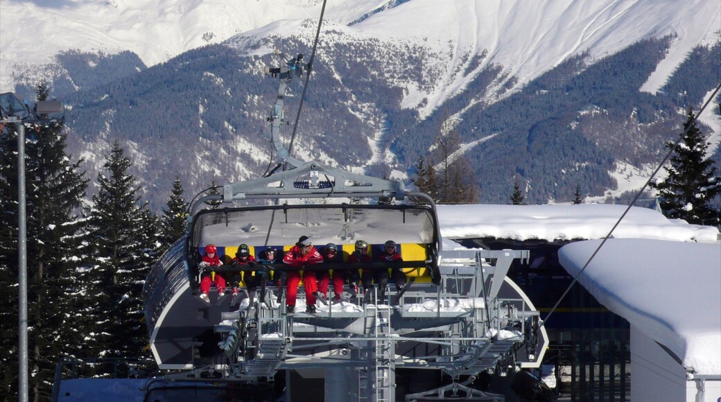 Serfaus which includes a gondola and snow as well as a large group of people