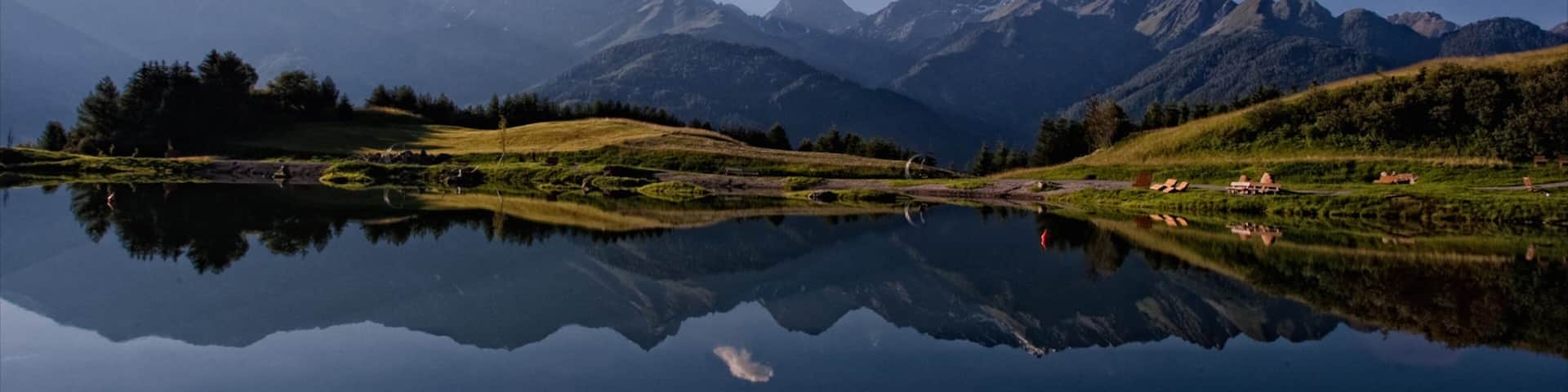 Serfaus which includes a lake or waterhole and mountains